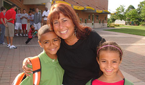 Children posing with teacher